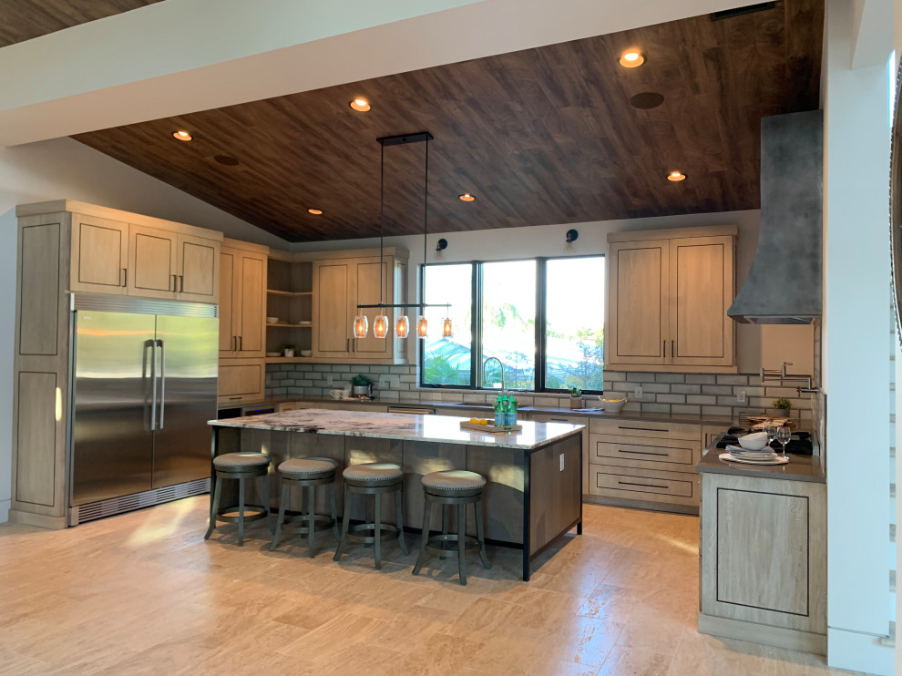 This is an example of a large midcentury u-shaped kitchen in Tampa with a submerged sink, flat-panel cabinets, light wood cabinets, granite worktops, grey splashback, terracotta splashback, stainless steel appliances, travertine flooring, an island, white floors and beige worktops.