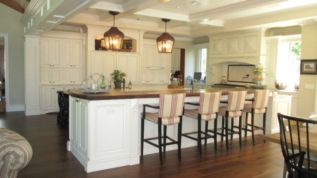 Inspiration for a large transitional galley dark wood floor eat-in kitchen remodel in Orlando with raised-panel cabinets, white cabinets, granite countertops, white backsplash, subway tile backsplash, paneled appliances and two islands