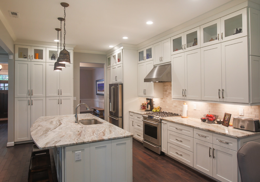 Example of a large arts and crafts galley dark wood floor open concept kitchen design in Other with an undermount sink, shaker cabinets, white cabinets, marble countertops, beige backsplash, ceramic backsplash, stainless steel appliances and an island