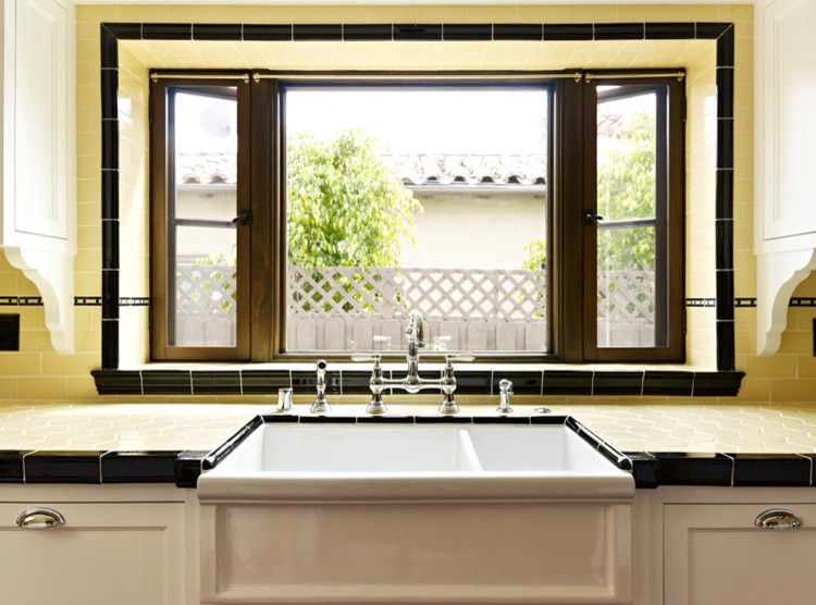 Inspiration for a mid-sized mediterranean terra-cotta tile and red floor enclosed kitchen remodel in Los Angeles with recessed-panel cabinets, white cabinets, tile countertops, yellow backsplash, subway tile backsplash, colored appliances, multicolored countertops, a farmhouse sink and no island