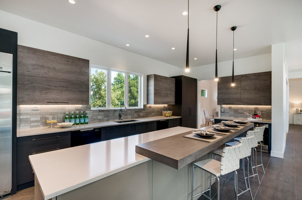 Large trendy porcelain tile and gray floor eat-in kitchen photo in Denver with an undermount sink, flat-panel cabinets, gray cabinets, quartz countertops, metallic backsplash, stainless steel appliances and two islands