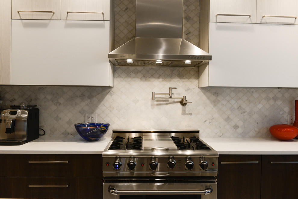 Mid-sized trendy l-shaped porcelain tile eat-in kitchen photo in New York with an undermount sink, flat-panel cabinets, brown cabinets, quartz countertops, gray backsplash, ceramic backsplash, stainless steel appliances and an island