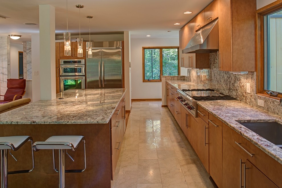 Inspiration for a large modern medium tone wood floor open concept kitchen remodel in Baltimore with an undermount sink, flat-panel cabinets, medium tone wood cabinets, granite countertops, multicolored backsplash, stone slab backsplash, stainless steel appliances and an island