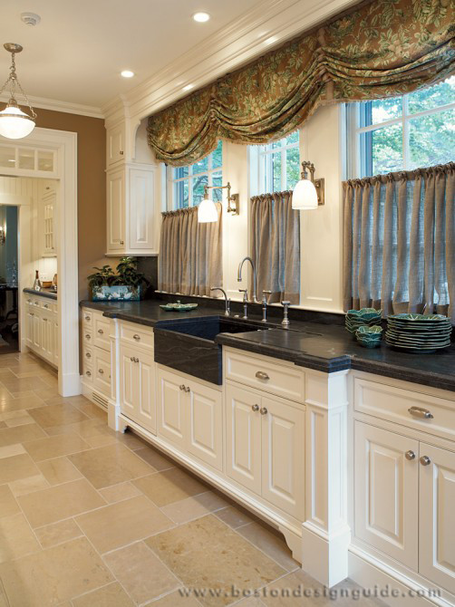 Example of a classic eat-in kitchen design in Boston with white cabinets, white backsplash and stainless steel appliances