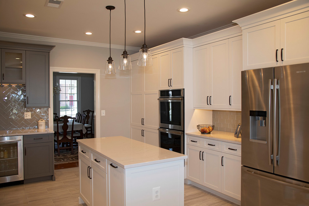Inspiration for a large traditional u-shaped kitchen in DC Metro with shaker cabinets, white cabinets and an island.
