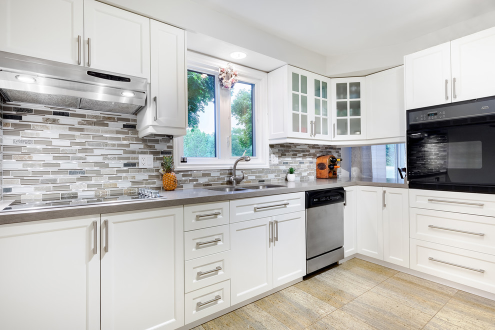 Example of a mid-sized trendy galley ceramic tile and beige floor enclosed kitchen design in Toronto with an undermount sink, shaker cabinets, white cabinets, quartz countertops, gray backsplash, glass tile backsplash, stainless steel appliances, no island and gray countertops