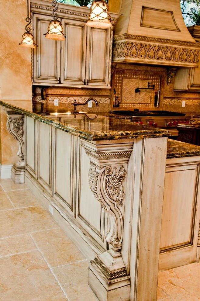 Inspiration for a timeless u-shaped eat-in kitchen remodel in Miami with distressed cabinets, raised-panel cabinets, granite countertops, beige backsplash, stainless steel appliances and an island