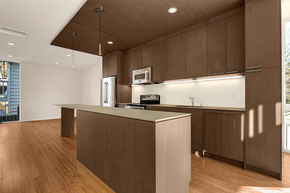 Eat-in kitchen - modern single-wall eat-in kitchen idea in Seattle with flat-panel cabinets, dark wood cabinets and stainless steel appliances
