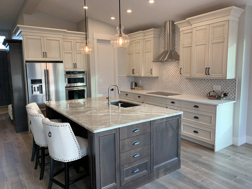 Inspiration for a large timeless l-shaped laminate floor and gray floor eat-in kitchen remodel in Calgary with an undermount sink, recessed-panel cabinets, distressed cabinets, quartz countertops, white backsplash, marble backsplash, stainless steel appliances, an island and white countertops