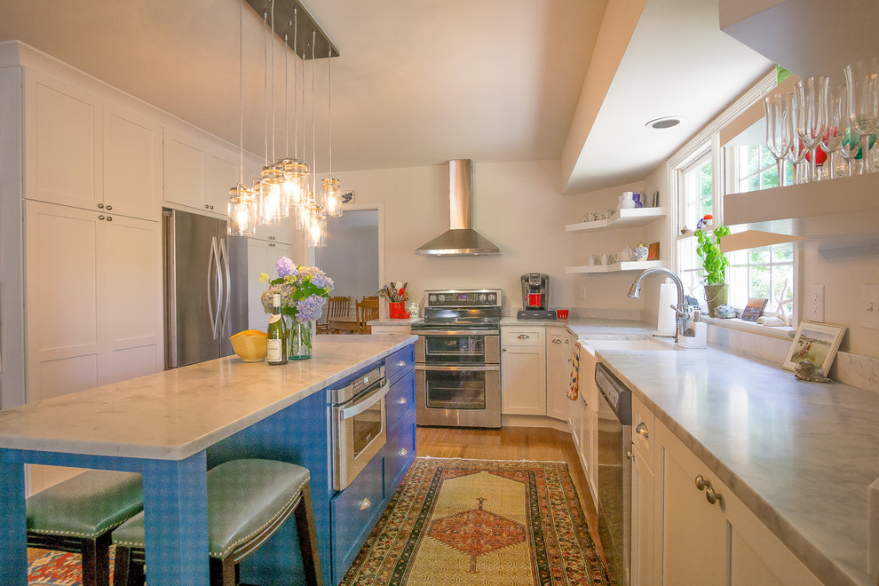 Bild på ett mellanstort lantligt kök, med en rustik diskho, skåp i shakerstil, vita skåp, marmorbänkskiva, rostfria vitvaror, ljust trägolv och en köksö