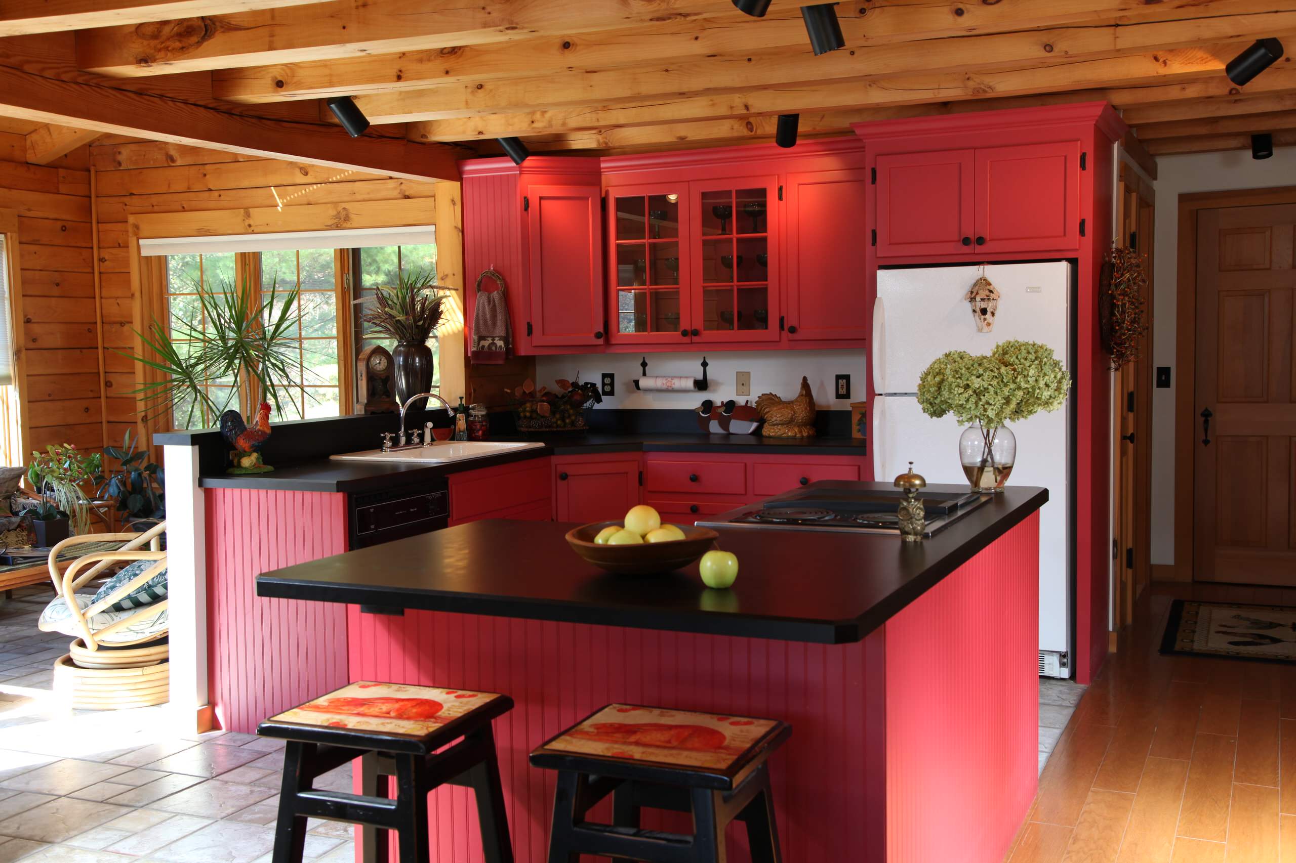 Severe Red Kitchen Has A Wooden Island And Several Cooking Appliances  Backgrounds