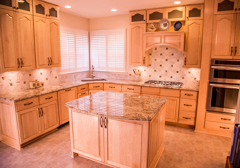 Photo of a classic u-shaped kitchen in Baltimore with a submerged sink, raised-panel cabinets, light wood cabinets, granite worktops, beige splashback, stainless steel appliances and ceramic flooring.