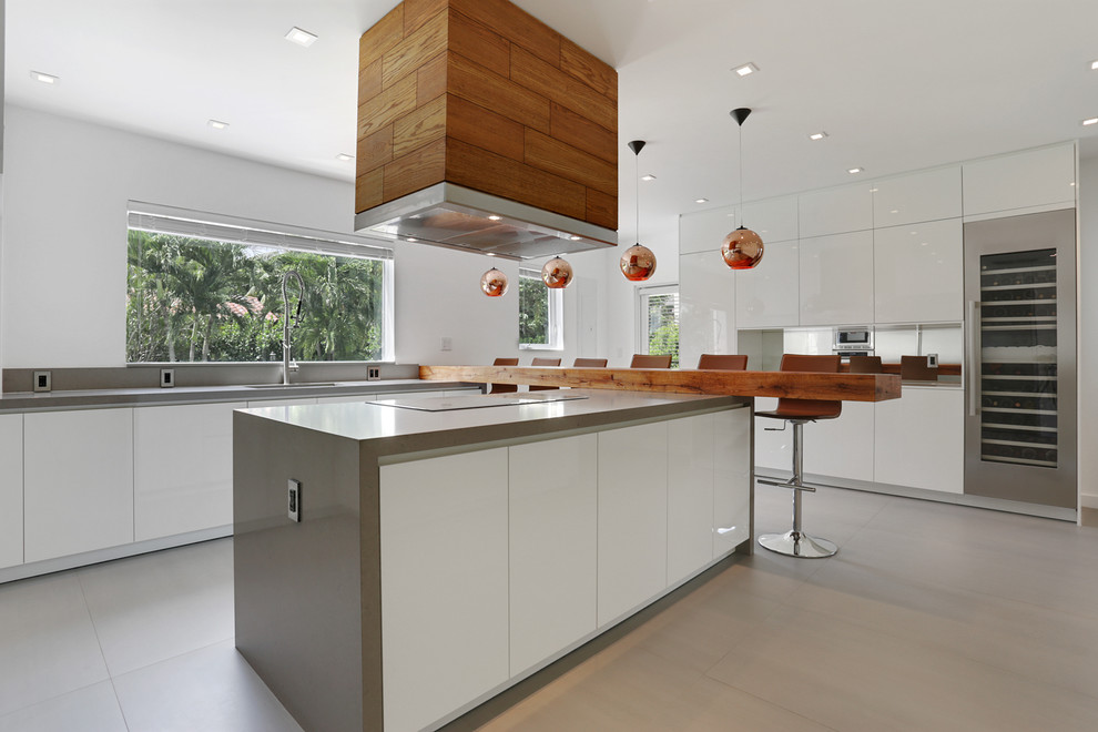 Inspiration for a mid-sized scandinavian u-shaped porcelain tile and beige floor eat-in kitchen remodel in Vancouver with an undermount sink, flat-panel cabinets, white cabinets, concrete countertops, gray backsplash, stainless steel appliances and an island