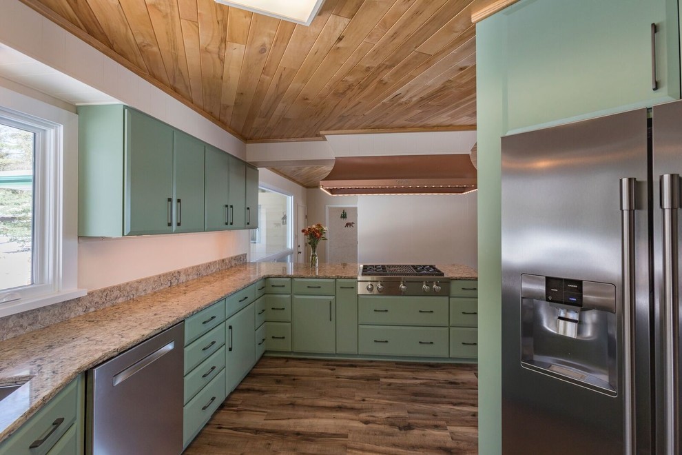 This is an example of a medium sized classic l-shaped kitchen/diner in Other with a submerged sink, flat-panel cabinets, green cabinets, engineered stone countertops, stainless steel appliances, vinyl flooring, a breakfast bar, brown floors and beige worktops.