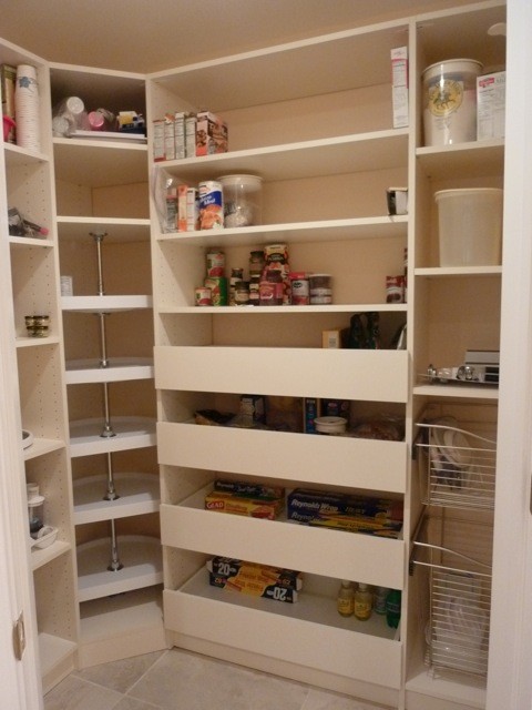 Photo of a small modern l-shaped kitchen pantry in New York with beige cabinets.