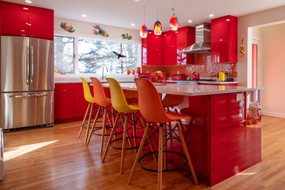 Photo of a medium sized contemporary l-shaped kitchen/diner in New York with a submerged sink, flat-panel cabinets, red cabinets, engineered stone countertops, multi-coloured splashback, ceramic splashback, stainless steel appliances, light hardwood flooring, an island, brown floors and white worktops.