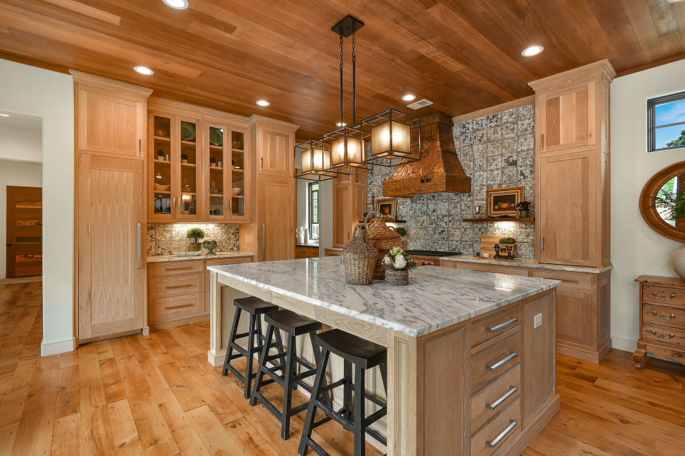 Inspiration for a large farmhouse medium tone wood floor and wood ceiling open concept kitchen remodel in Atlanta with a farmhouse sink, shaker cabinets, light wood cabinets, granite countertops, multicolored backsplash, porcelain backsplash, stainless steel appliances, an island and white countertops