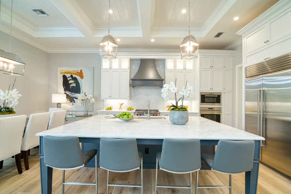 Traditional u-shaped kitchen/diner in Miami with a submerged sink, recessed-panel cabinets, white cabinets, marble worktops, white splashback, stainless steel appliances, medium hardwood flooring, an island, brown floors, a timber clad ceiling and a drop ceiling.