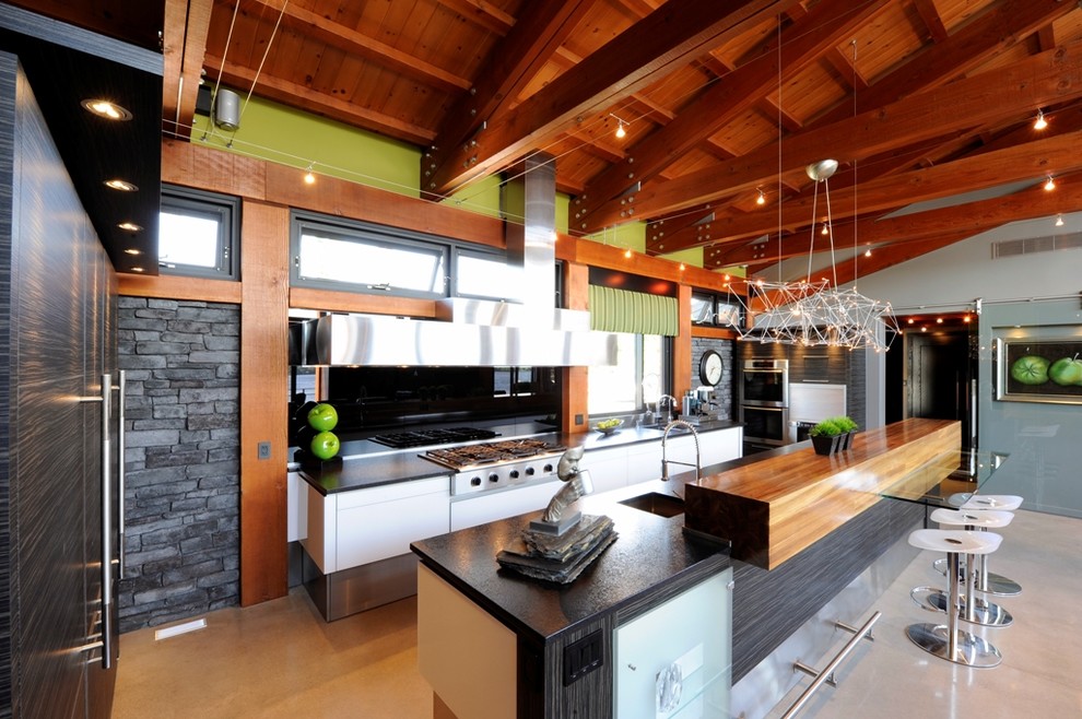 Eat-in kitchen - large contemporary l-shaped concrete floor eat-in kitchen idea in Ottawa with an integrated sink, flat-panel cabinets, dark wood cabinets, quartz countertops, metallic backsplash, mirror backsplash, white appliances and an island