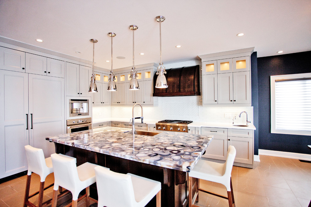 Inspiration for a transitional l-shaped kitchen remodel in Toronto with recessed-panel cabinets, gray cabinets, white backsplash and paneled appliances