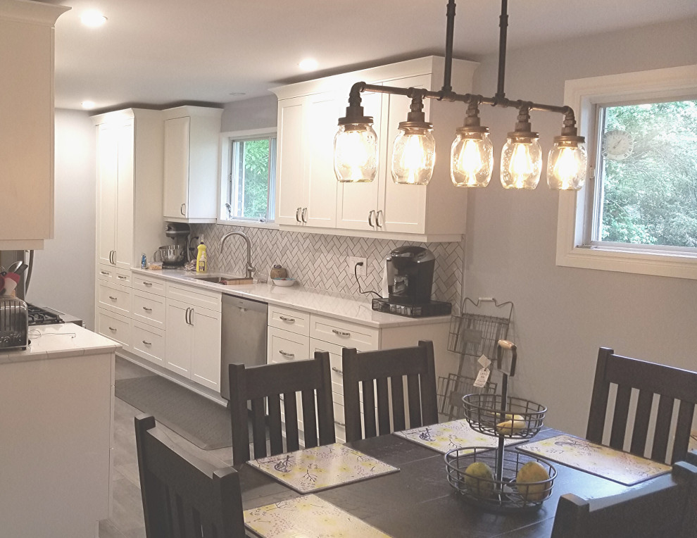 This is an example of a classic kitchen/diner in Other with shaker cabinets, white cabinets, composite countertops, white splashback, vinyl flooring, no island and white worktops.