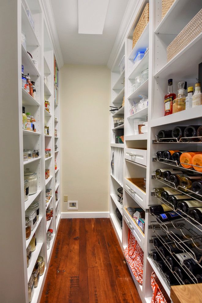 This is an example of a mid-sized traditional galley kitchen pantry in Jacksonville with wood benchtops, stainless steel appliances and dark hardwood floors.
