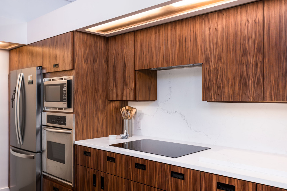 This is an example of a medium sized modern galley kitchen/diner in Other with a submerged sink, flat-panel cabinets, brown cabinets, stainless steel appliances and white worktops.