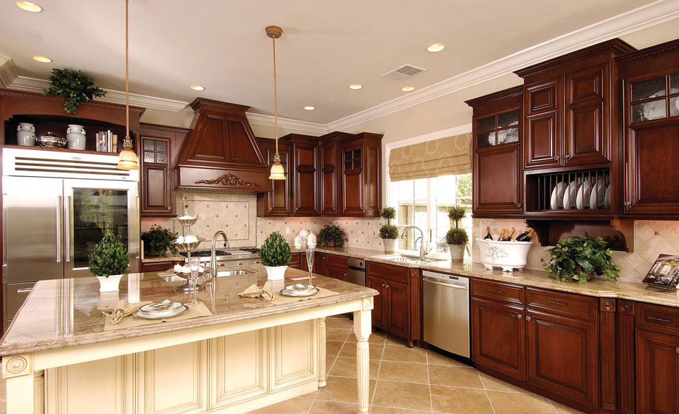 Example of a large classic u-shaped ceramic tile eat-in kitchen design in New Orleans with a double-bowl sink, raised-panel cabinets, medium tone wood cabinets, granite countertops, beige backsplash, ceramic backsplash, stainless steel appliances and an island