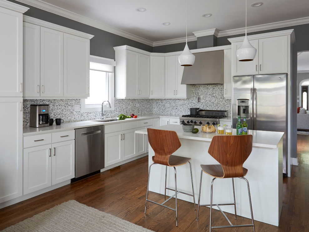 Inspiration for a medium sized traditional open plan kitchen in Chicago with a submerged sink, shaker cabinets, white cabinets, engineered stone countertops, stone tiled splashback, stainless steel appliances, dark hardwood flooring and an island.