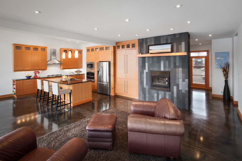 Contemporary open plan kitchen in Vancouver with flat-panel cabinets, medium wood cabinets and stainless steel appliances.