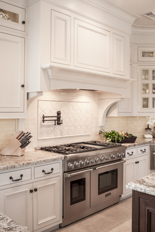 Classic u-shaped kitchen/diner in Houston with a submerged sink, beaded cabinets, beige cabinets, granite worktops, beige splashback and stainless steel appliances.