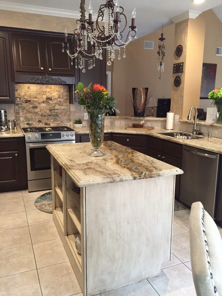 Inspiration for a large transitional u-shaped ceramic tile eat-in kitchen remodel in Houston with an undermount sink, recessed-panel cabinets, brown cabinets, granite countertops, beige backsplash, stone tile backsplash, stainless steel appliances and an island