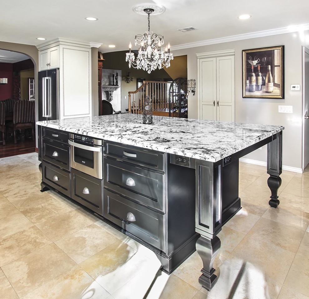 Inspiration for a traditional kitchen in Orange County with flat-panel cabinets and an island.