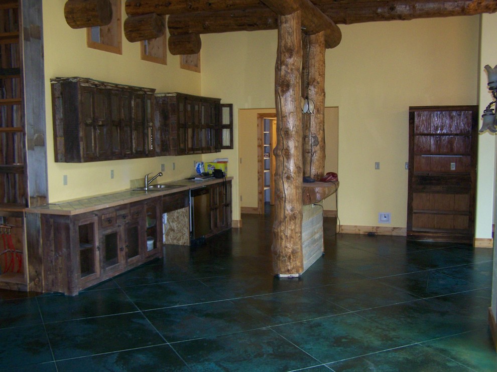 Cette photo montre une petite cuisine linéaire sud-ouest américain en bois vieilli avec un évier posé, un électroménager en acier inoxydable et sol en béton ciré.
