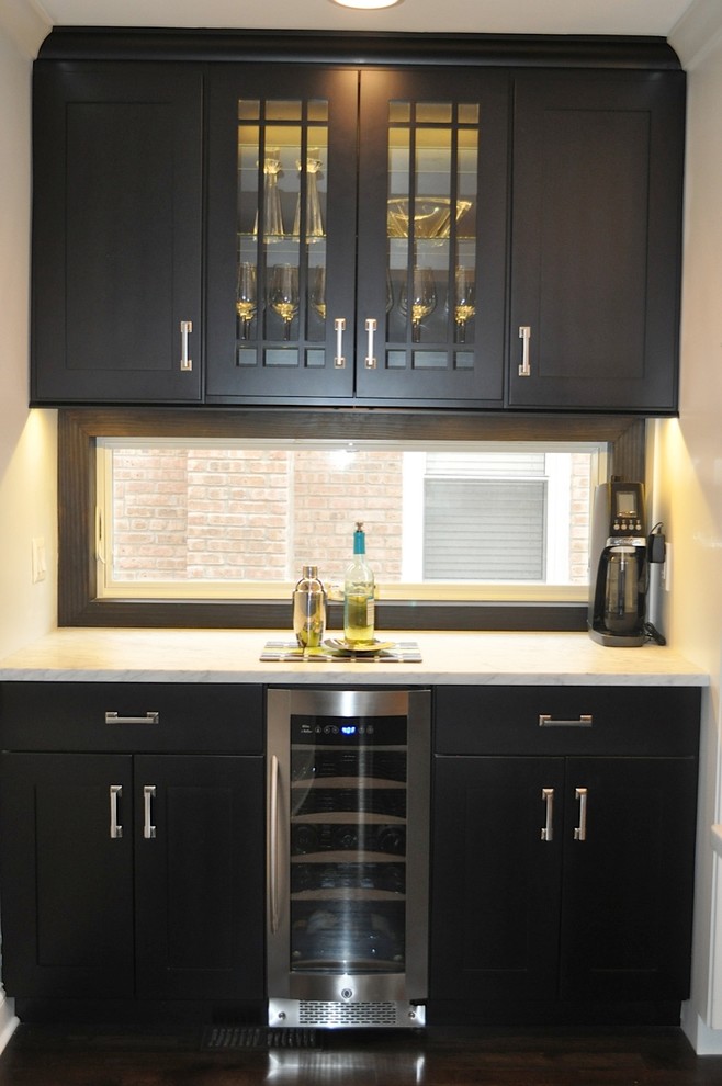 Inspiration for a mid-sized contemporary l-shaped dark wood floor home bar remodel in Chicago with flat-panel cabinets, white cabinets, granite countertops, multicolored backsplash and mosaic tile backsplash