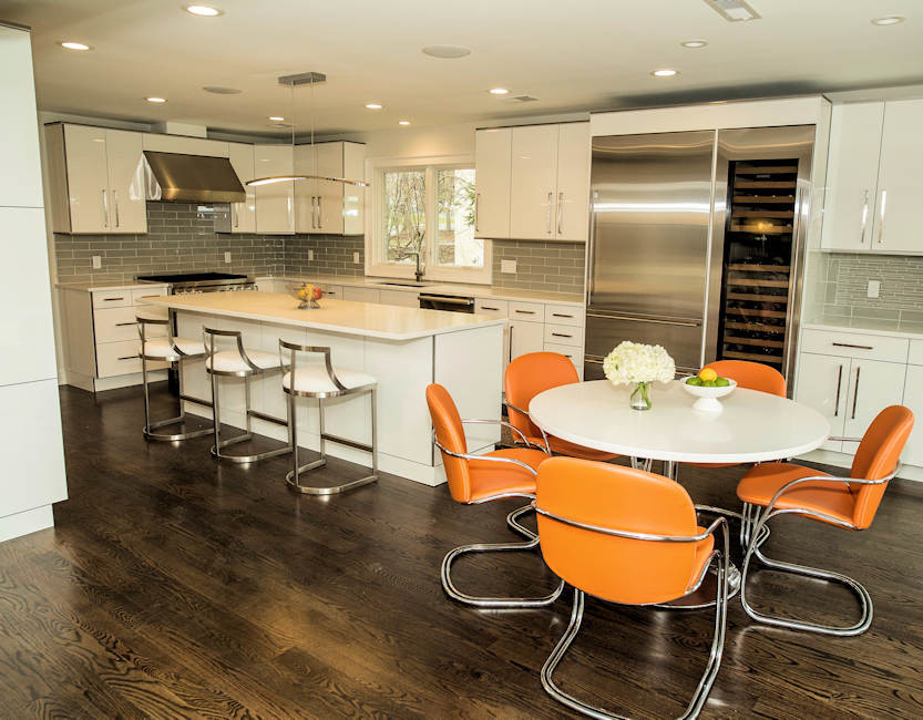 Example of a large trendy galley dark wood floor eat-in kitchen design in New York with an undermount sink, flat-panel cabinets, white cabinets, quartzite countertops, gray backsplash, ceramic backsplash, stainless steel appliances and an island