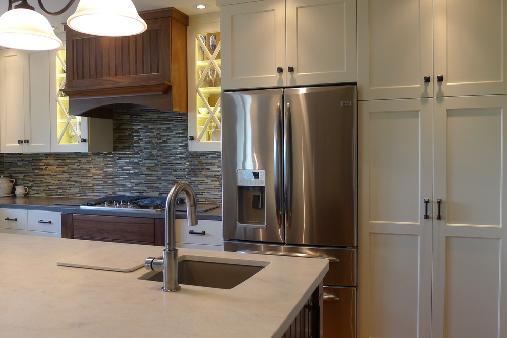Eat-in kitchen - transitional l-shaped eat-in kitchen idea in Indianapolis with an undermount sink, flat-panel cabinets, white cabinets, solid surface countertops, multicolored backsplash, matchstick tile backsplash and stainless steel appliances