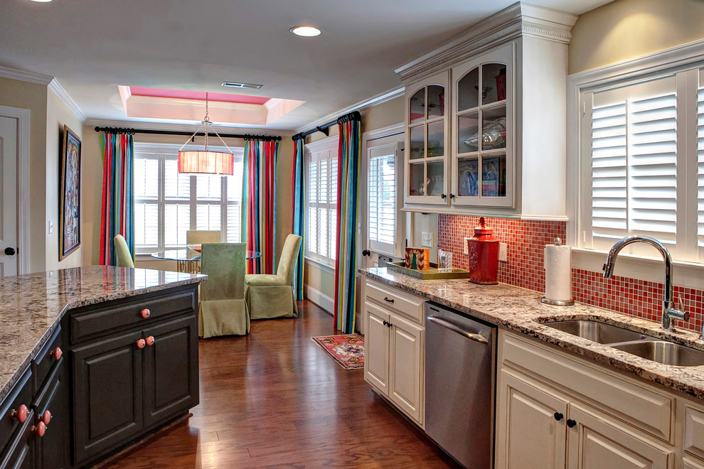Inspiration for a large transitional l-shaped eat-in kitchen remodel in Charleston with a drop-in sink, raised-panel cabinets, beige cabinets, granite countertops, red backsplash, mosaic tile backsplash, stainless steel appliances and an island