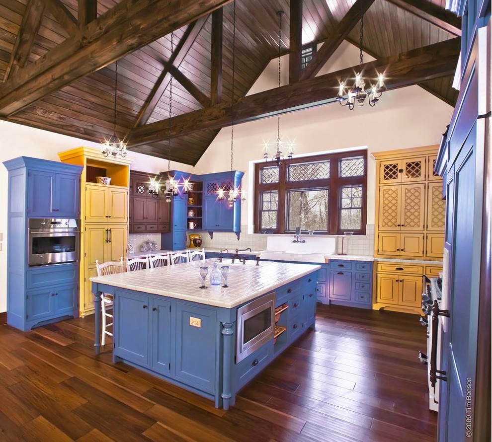 Example of an eat-in kitchen design in Other with white backsplash and an island