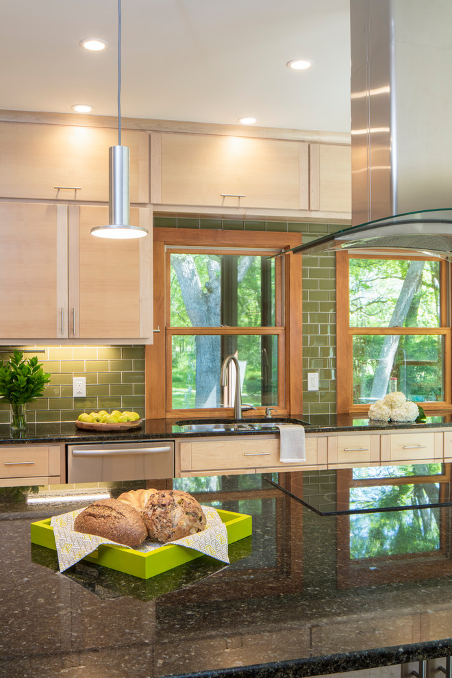 Medium sized contemporary kitchen in Austin with flat-panel cabinets, light wood cabinets, granite worktops, green splashback, glass tiled splashback, stainless steel appliances and an island.