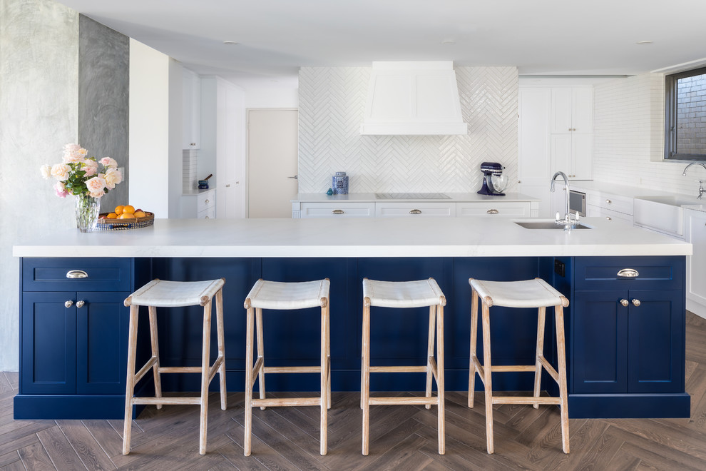 Example of a classic kitchen design in Perth with shaker cabinets, blue cabinets, quartz countertops, white backsplash, ceramic backsplash, two islands and gray countertops