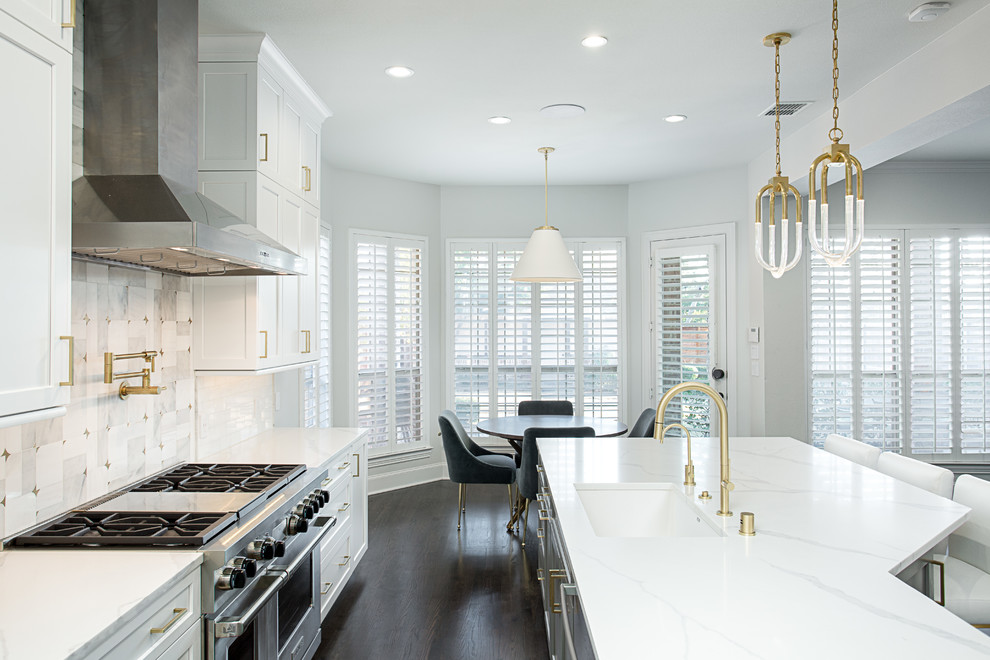 Inspiration for a huge transitional galley dark wood floor and brown floor open concept kitchen remodel in Dallas with an undermount sink, shaker cabinets, white cabinets, quartz countertops, white backsplash, marble backsplash, stainless steel appliances and an island