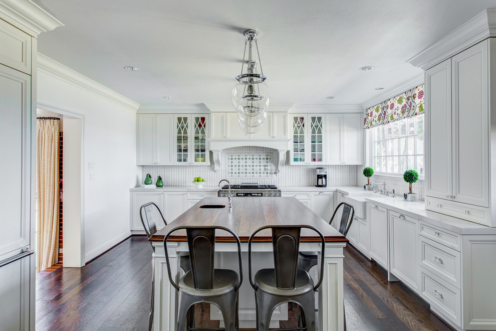 Inspiration for a large timeless l-shaped dark wood floor and brown floor kitchen remodel in Dallas with shaker cabinets, white cabinets, white backsplash and an island