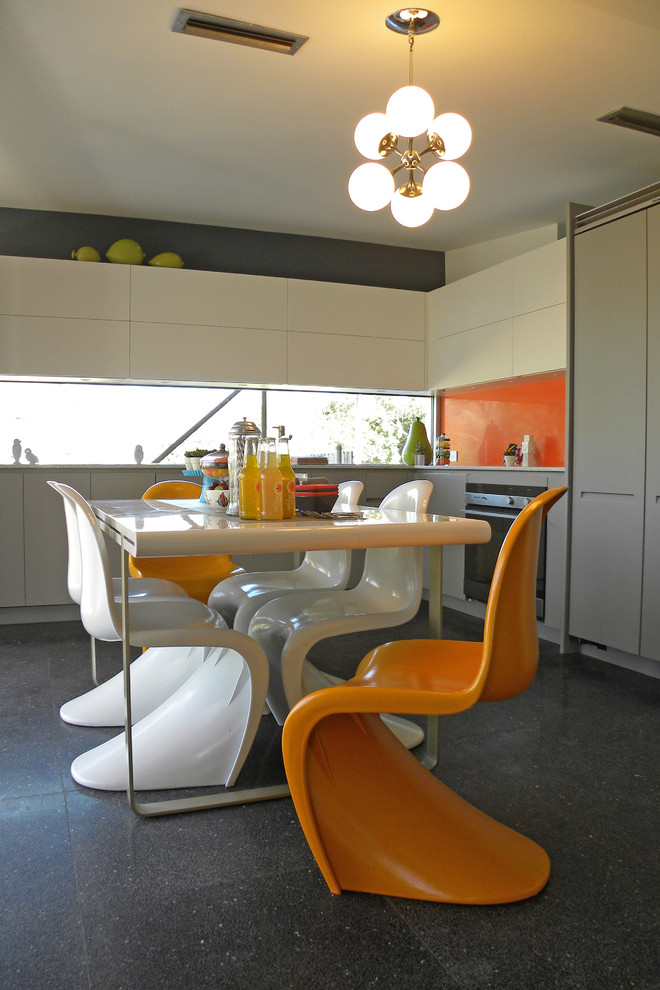Kitchen - 1960s kitchen idea in Dallas with flat-panel cabinets, white cabinets, orange backsplash and glass sheet backsplash