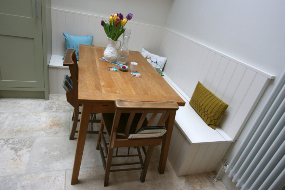 Cette photo montre une petite salle à manger ouverte sur la cuisine chic avec un sol en calcaire et un sol beige.