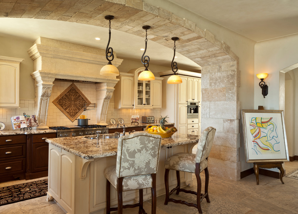 Tuscan kitchen photo in Los Angeles with raised-panel cabinets, beige cabinets, beige backsplash and limestone backsplash