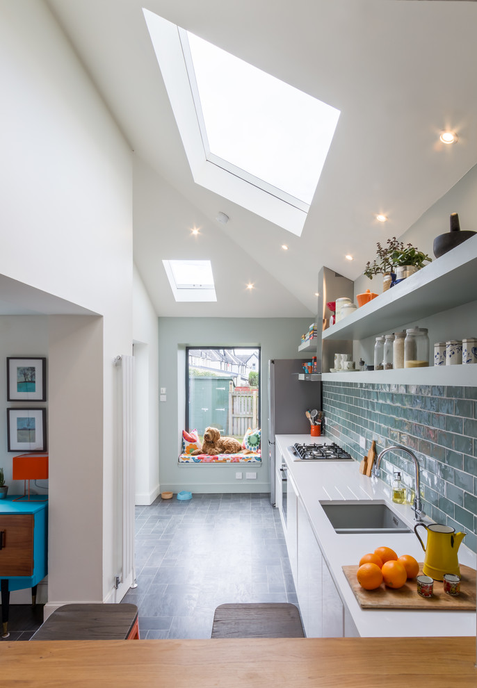 Example of a trendy single-wall kitchen design in Glasgow with an undermount sink, flat-panel cabinets and white cabinets