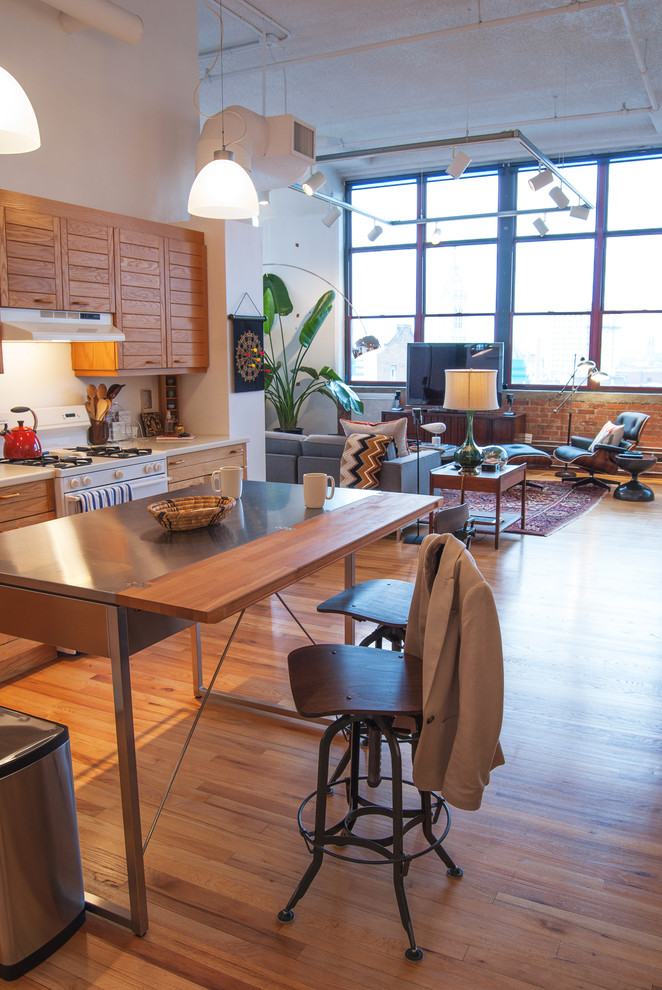 Example of an urban open concept kitchen design in Other with louvered cabinets, medium tone wood cabinets, stainless steel countertops and white appliances