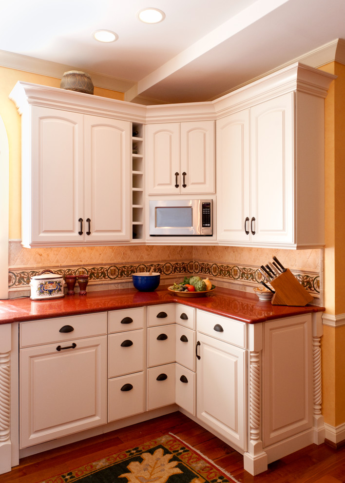 Inspiration for a mediterranean kitchen remodel in St Louis with red countertops