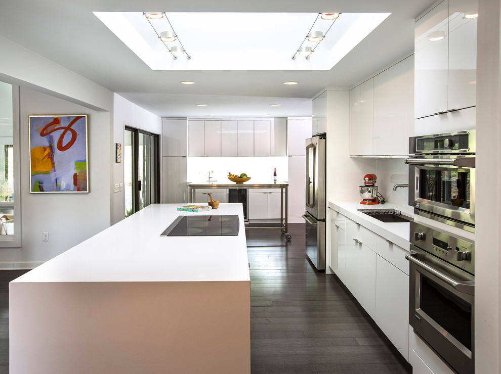 Exempel på ett mellanstort modernt vit linjärt vitt kök och matrum, med en undermonterad diskho, släta luckor, vita skåp, bänkskiva i koppar, rostfria vitvaror, mörkt trägolv, en köksö och brunt golv